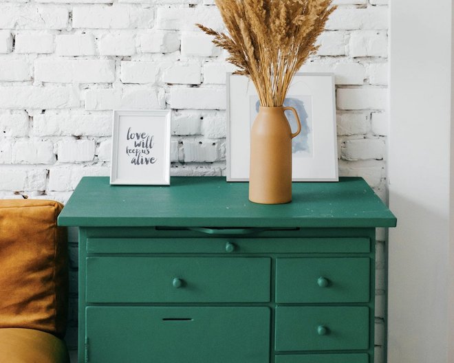 green drawer with photos and plant on top